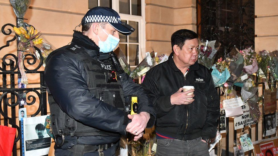  Myanmar's ambassador to the UK Kyaw Zwar Minn (R) speaks to a police officer outside the embassy in London. PA Media